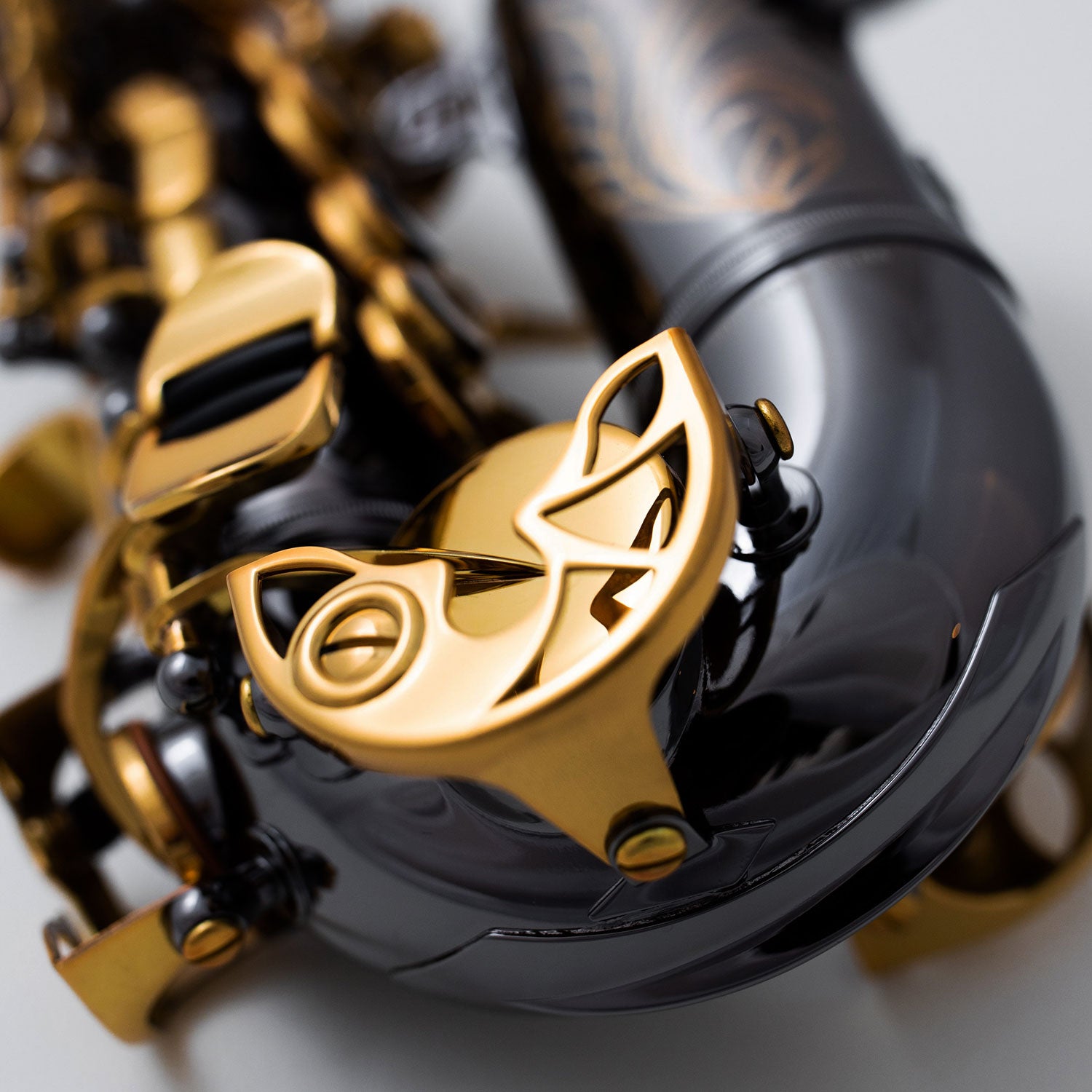 Close-up of Cannonball A5-BL bell and lower key mechanism in black nickel and gold lacquer finish